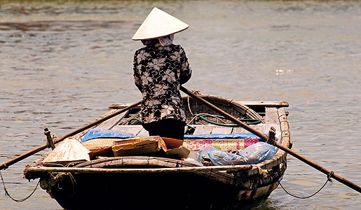 Woman in rowboat, Hoi An, Vietnam.